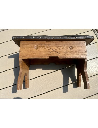 Stool - brown wood with padded top in brown and with nails