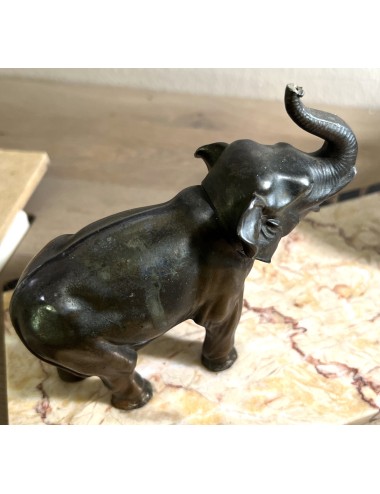 Statue on marble base with 2 elephants - one larger and one smaller elephant