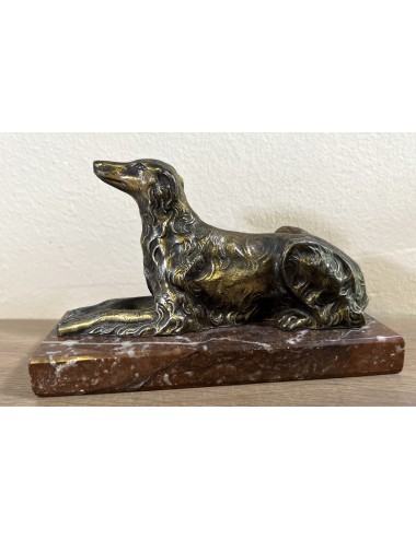 Figurine of an Afghan greyhound(?) in copper-colored metal on a brown/red marbled base