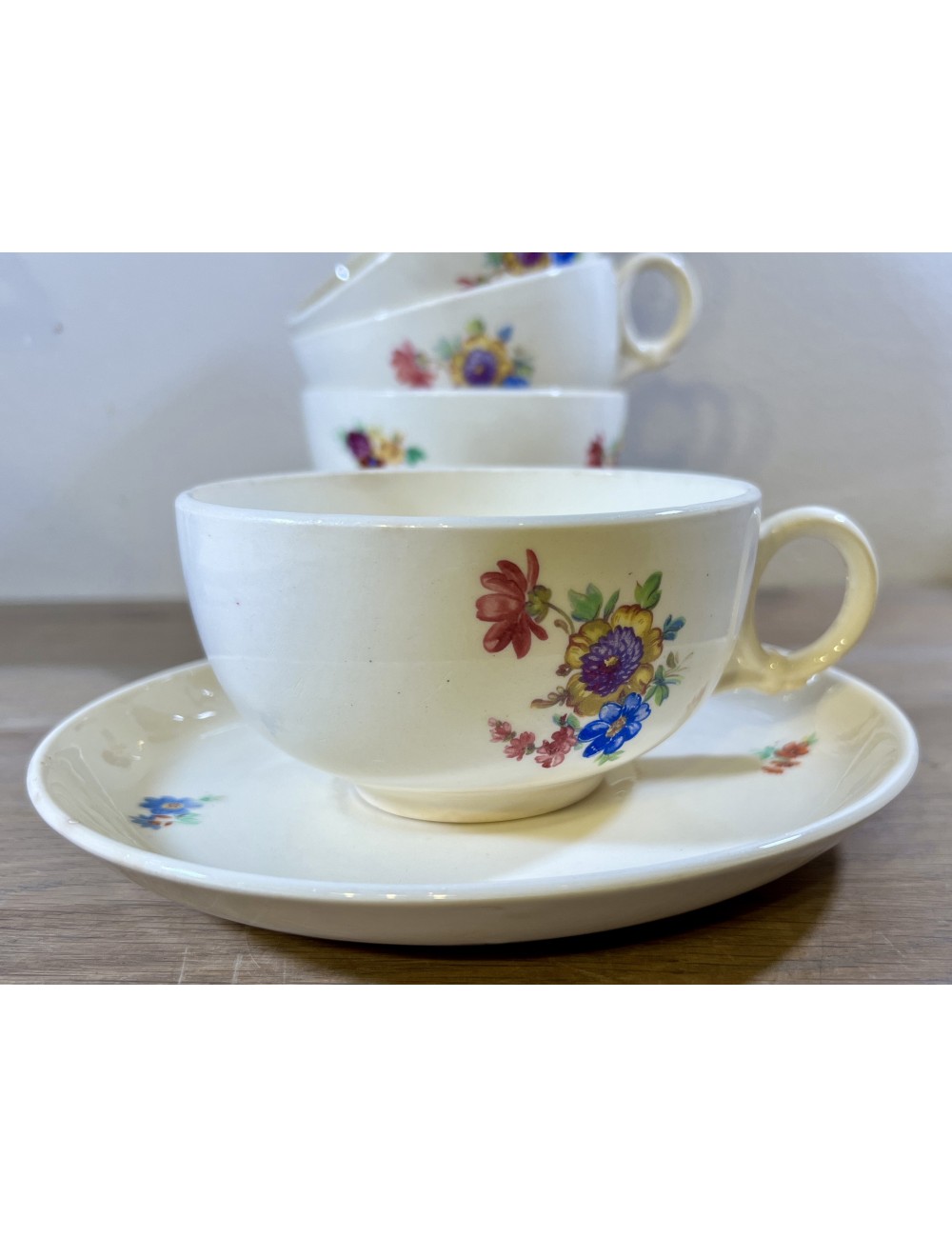 Cup and saucer - larger model - unmarked but Petrus Regout - shape BOUDEWIJN(?) - décor with colored flowers