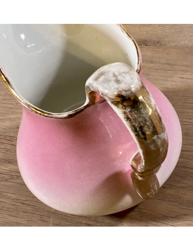 Milk jug - Petrus Regout - décor in cream color overflowing into pink color with gold color rim and handle